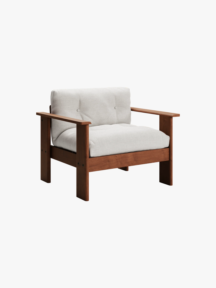 Wood lounge chair with a plush removable seat cushion.