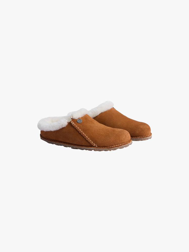 Slippers made of suede with a genuine shearling lining contoured cork footbed.