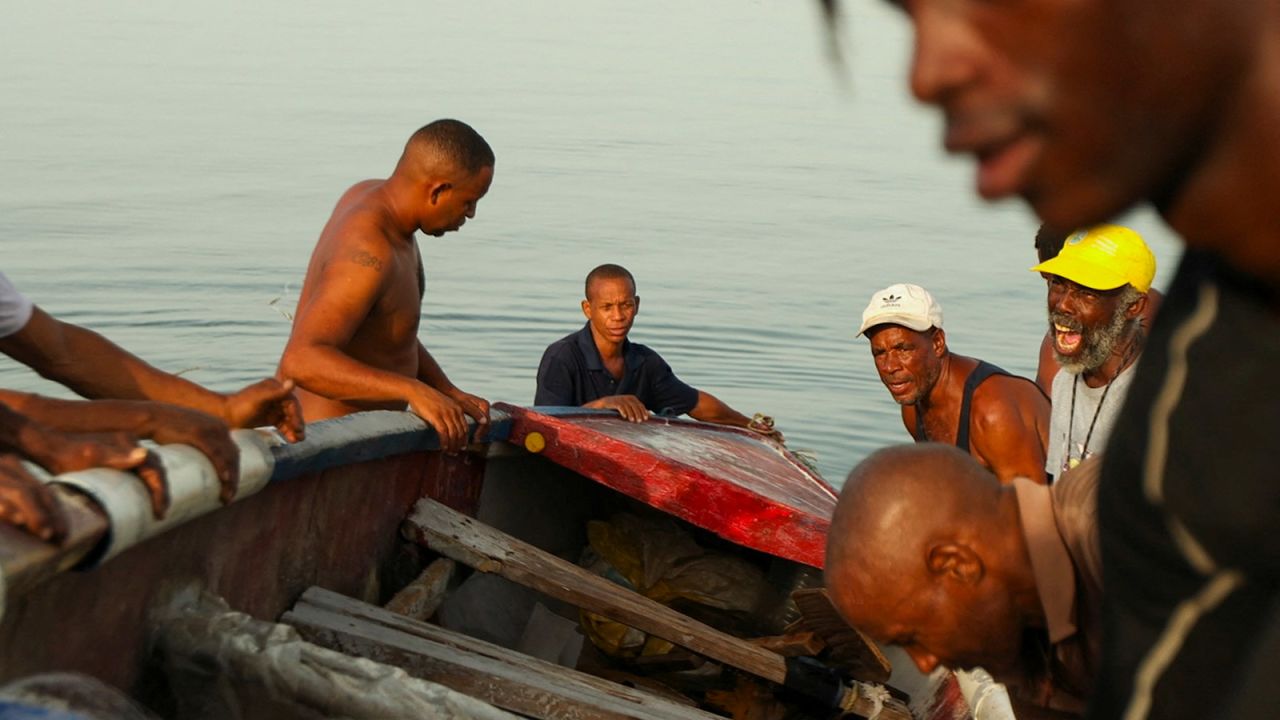 Jamaican fishermen help each other prepare for the approaching Hurricane Beryl by bringing boats inland, in Kingston, Jamaica, on July 2. 