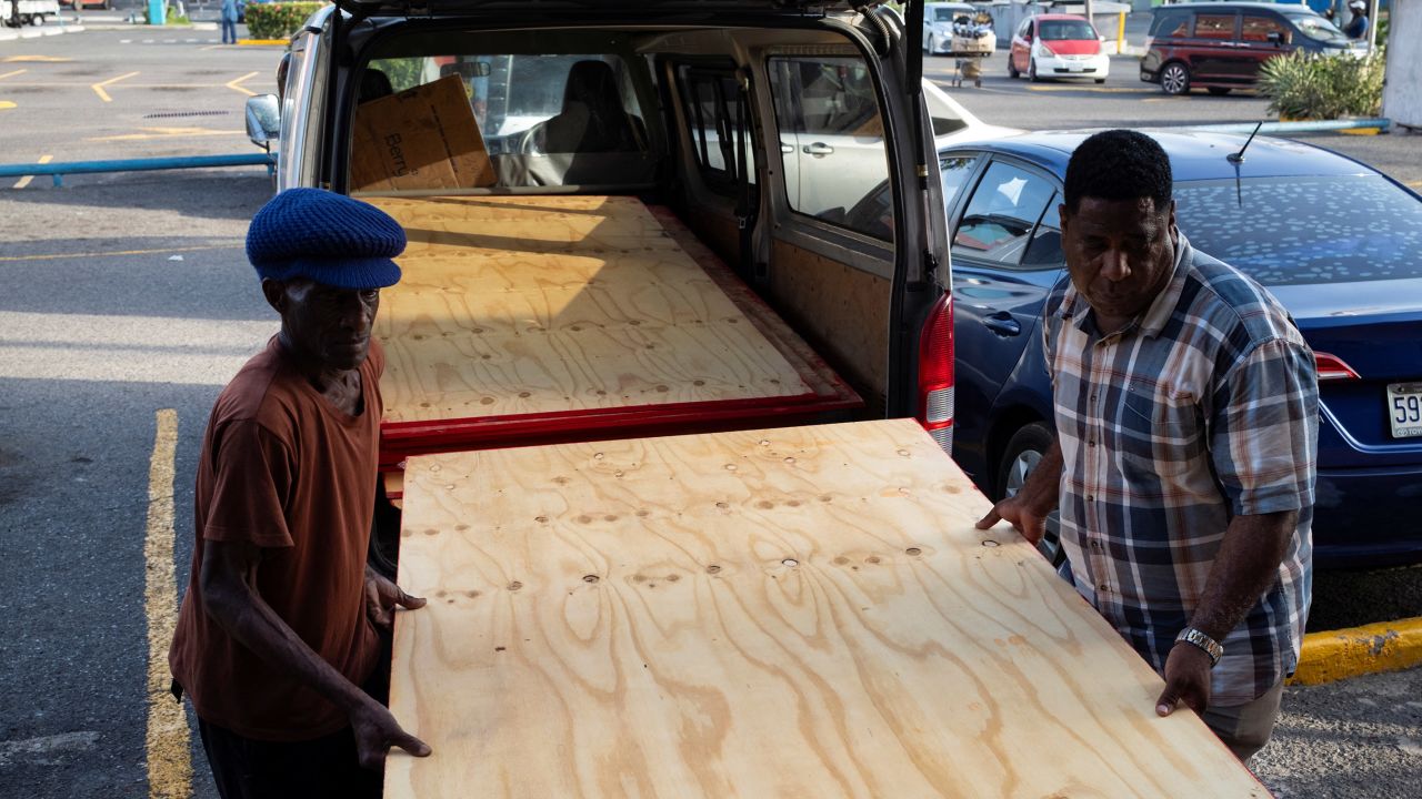 Workers carry plywood as they board up a restaurant, as Hurricane Beryl approaches, in Kingston, Jamaica, on July 2.