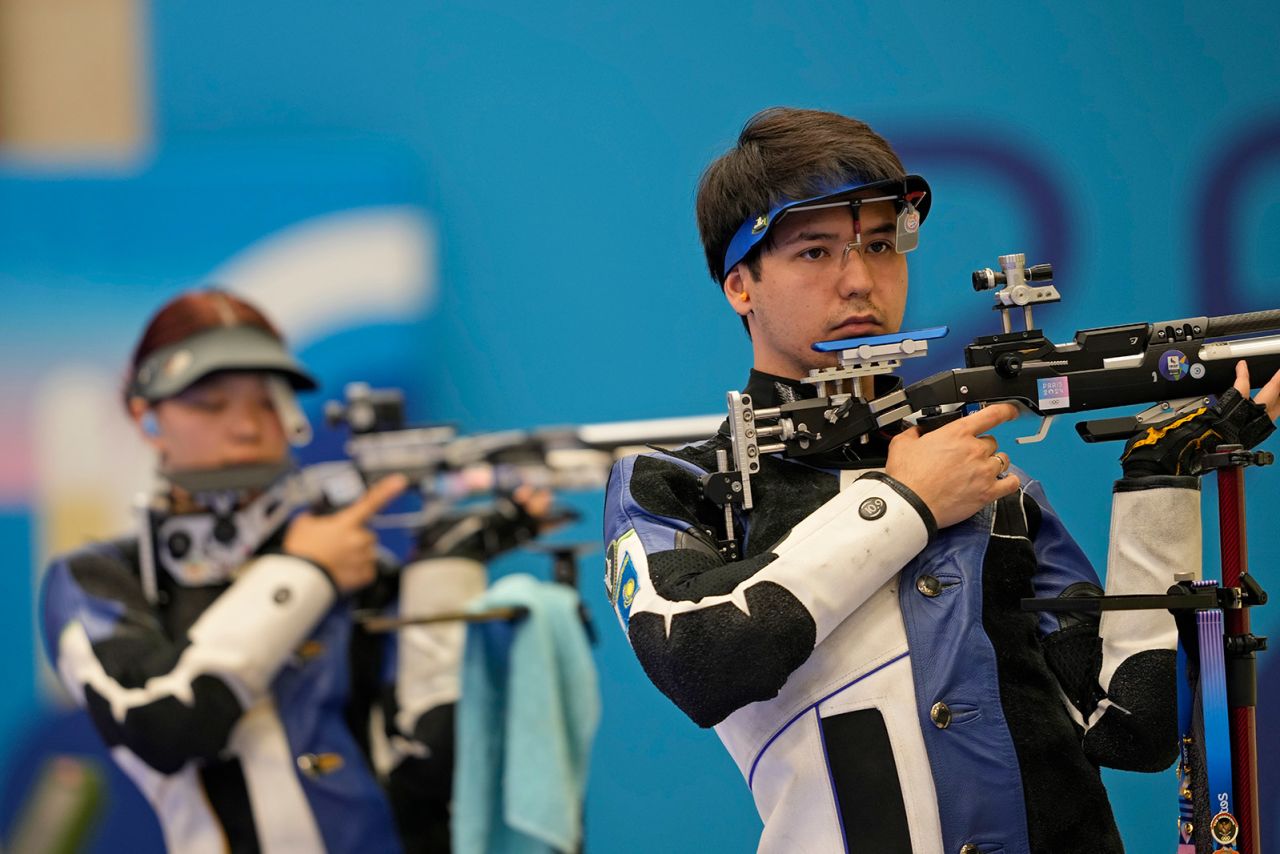 Islam Satpayev, right, and Alexandra Le of Kazakhstan compete for the bronze medal in the 10m air rifle mixed team medal round at the 2024 Summer Olympics on July 27. The Kazakh pair went on to win the bronze medal. 