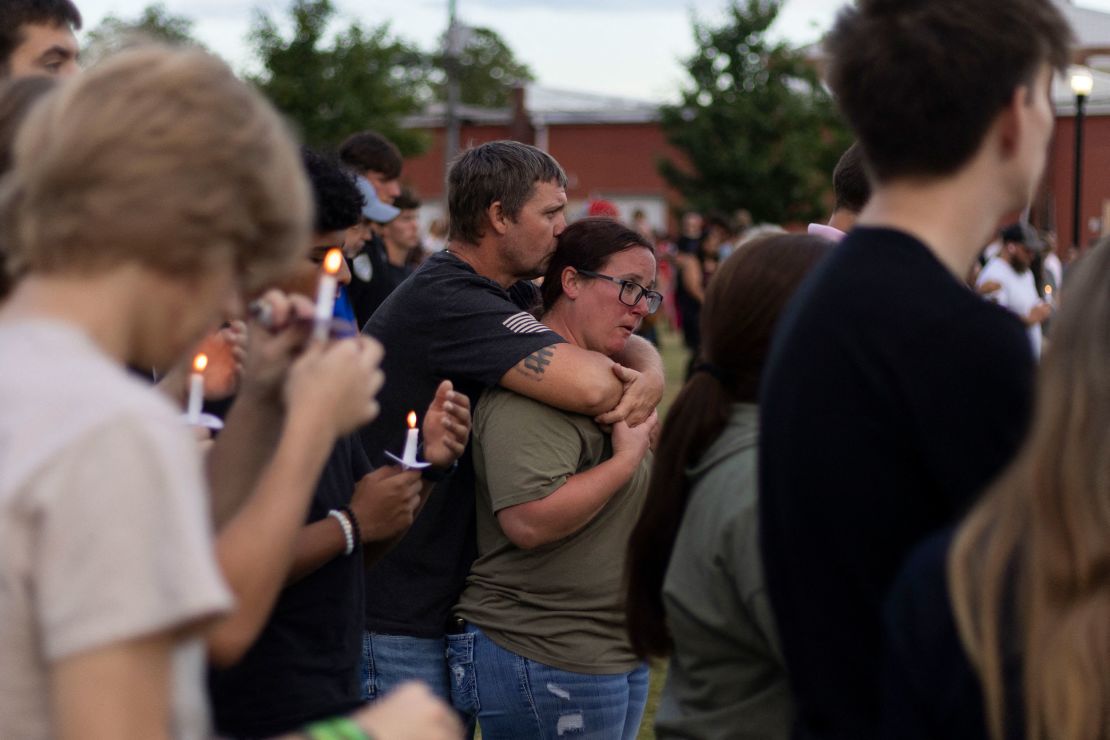 Mourners grieve the deaths of two students and two teachers at Apalachee High School in Winder, Georgia.