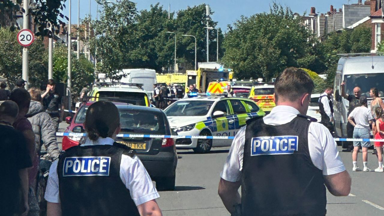 Emergency services and police are seen at the scene of a stabbing in Southport, England on Monday.