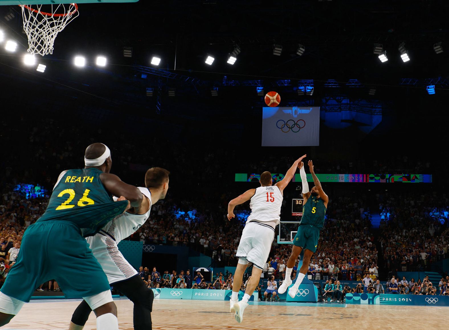 Australia's Patty Mills makes a shot over Serbia's Nikola Jokić during their quarterfinal game on August 6.