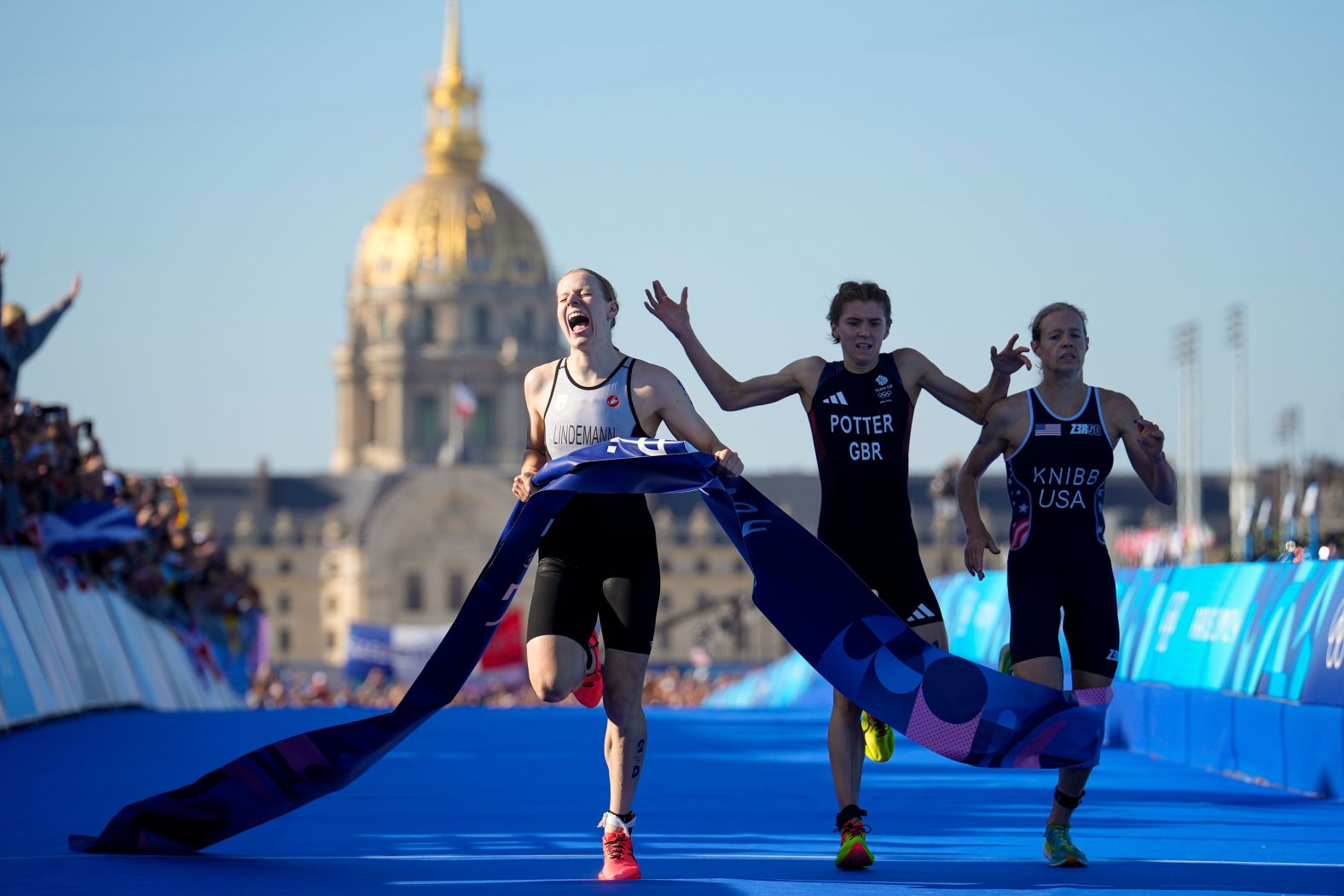 Triathlete Laura Lindemann, left, celebrates after she crossed the finish line <a href="https://www.cnn.com/sport/live-news/paris-olympics-news-2024-08-05#h_1daac4b41669abd11d80548ac2296483">to give Germany gold in the mixed relay</a> on August 5.