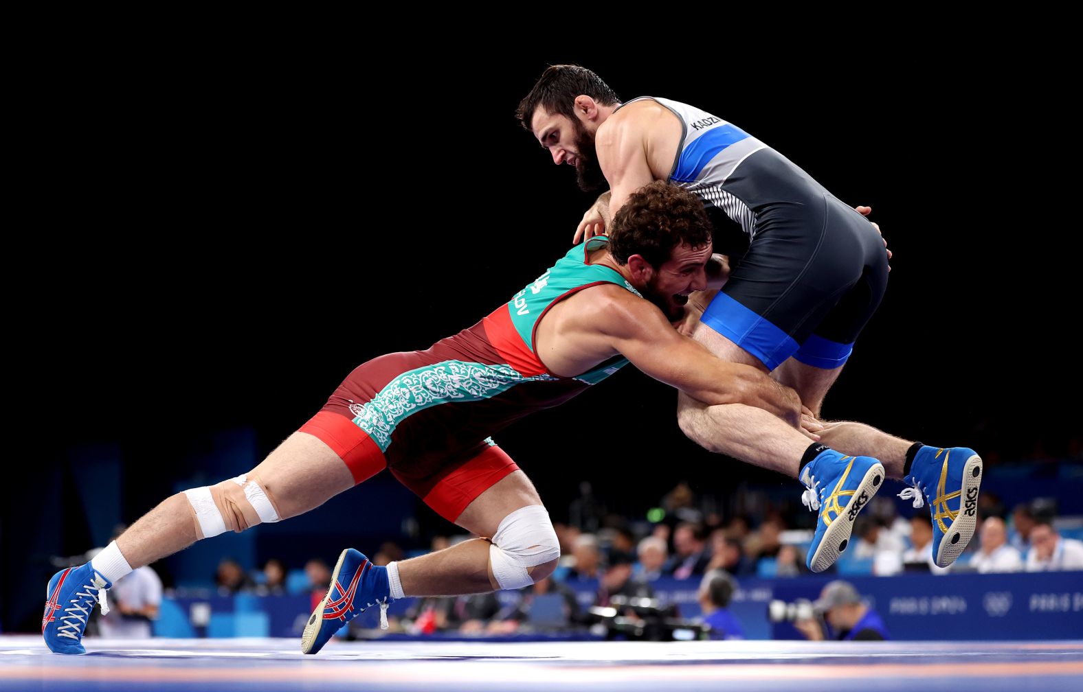 Uzbekistan's Razambek Zhamalov, left, wrestles Mahamedkhabib Kadzimahamedau, a member of the neutral athletes team, on August 9. Amid the <a href="https://www.cnn.com/world/europe/ukraine">ongoing war in Ukraine</a>, the International Olympic Committee <a href="https://www.cnn.com/2023/12/08/sport/russian-belarusian-athletes-olympics-paris-2024-spt-intl/index.html">announced in December</a> that Russian and Belarusian athletes would only be eligible to compete as individual neutral athletes at this year’s Olympics.