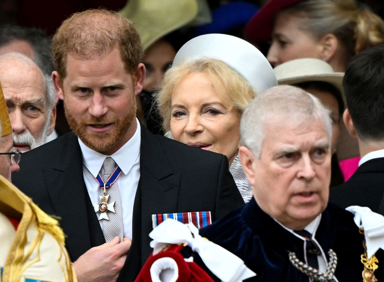 Britain's Prince Harry, Duke of Sussex, and Prince Andrew leave Westminster Abbey following the coronation ceremony of Britain's King Charles and Queen Camilla.