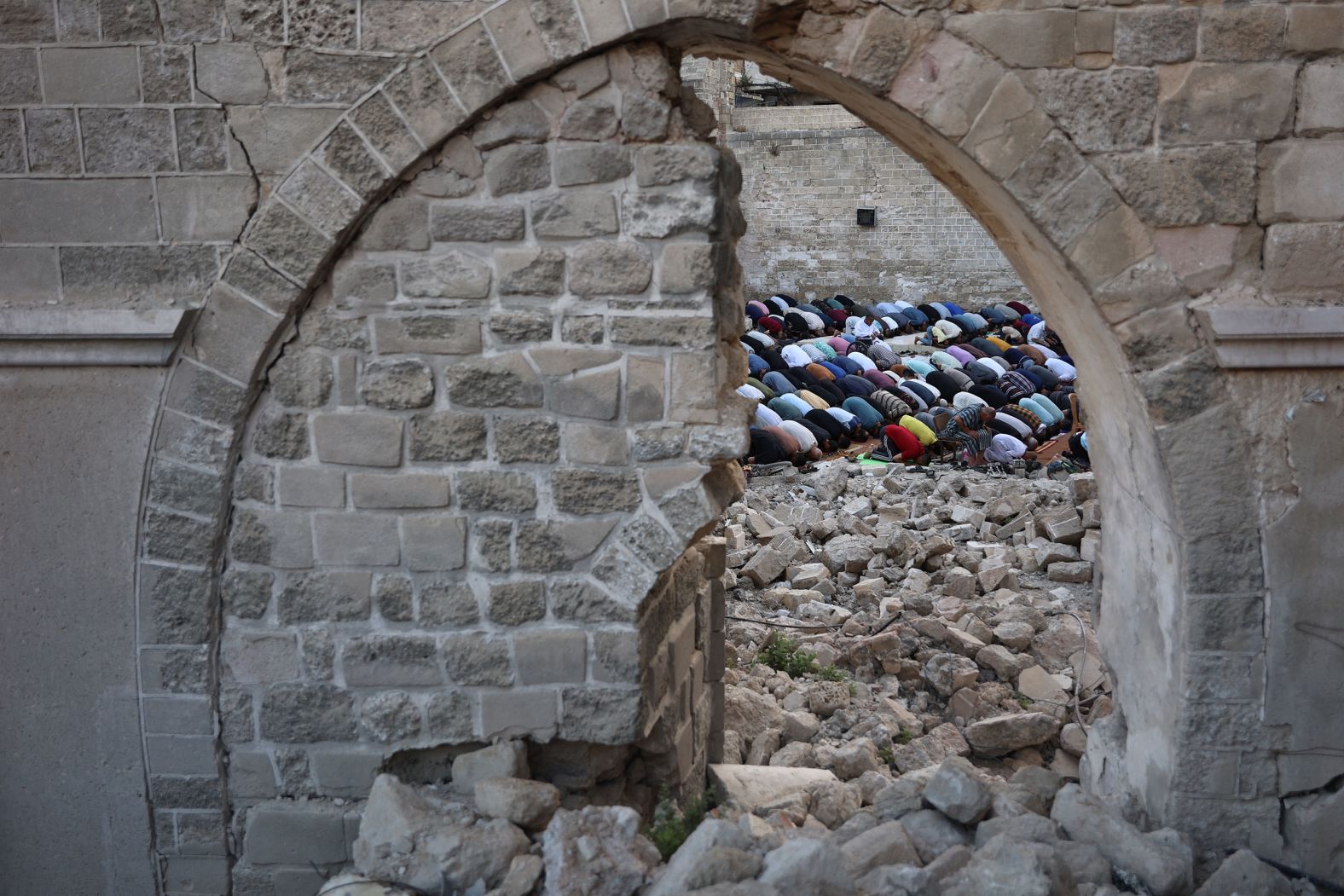 Palestinians perform Eid al-Adha morning prayers in the courtyard of Gaza City’s historic Omari Mosque on Sunday, June 16. The mosque was damaged by Israeli bombardment in Gaza.