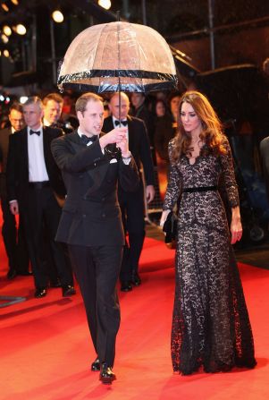 Prince William kept his wife dry at the London premiere of "War Horse" on January 8, 2012. She wore a black lace <a href="http://nymag.com/daily/fashion/2012/01/kate-middleton-war-horse-premiere-temperley.html" target="_blank" target="_blank">Alice by Temperley</a> gown and carried a black clutch.