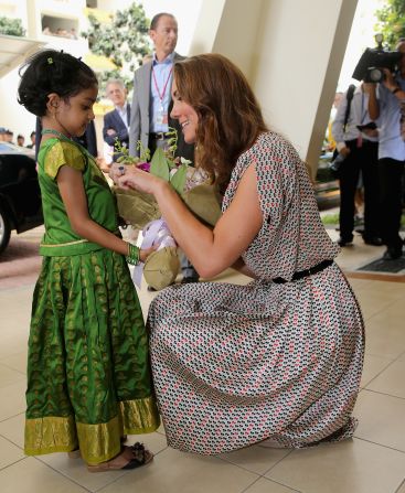 A young girl gives flowers to Catherine on Wednesday.