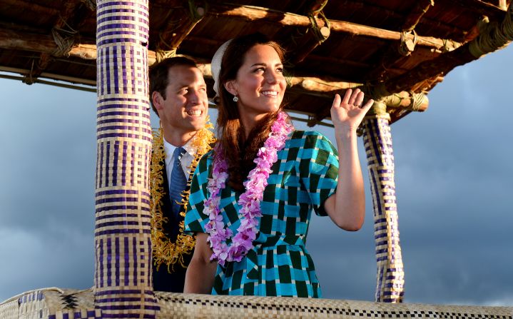 Britain's Prince William and his wife, Catherine, Duchess of Cambridge, wave to Solomon Islanders as they leave the airport aboard a truck decorated as a canoe in Honiara on Sunday.