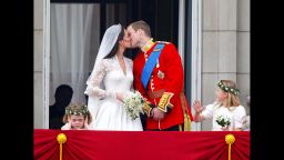 Image #: 14025679    Prince William and his wife Kate Middleton, who has been given the title of The Duchess of Cambridge, kiss on the balcony of Buckingham Palace, London watched by bridesmaids Margarita Armstrong-Jones (right) and Grace Van Cutsem (left), following their wedding at Westminster Abbey.       PA PHOTOS /LANDOV