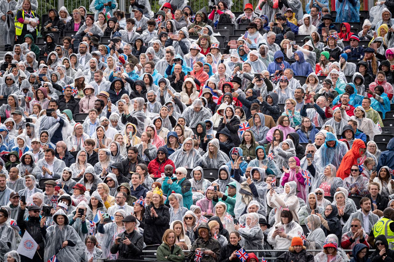 Crowds wait to see Britain's King Charles III and Queen Camilla on the way back to Buckingham Palace. 