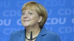 German Chancellor Angela Merkel reacts after the first exit polls in the country's election were released on September 22, 2013.