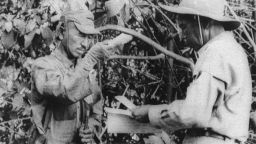 It's true: Former Imperial Japanese Army soldier Hiroo Onoda (left) accepts a pack of cigarettes from a member of a Japanese team sent to persuade him the war had ended, on Lubang Island in the Philippines in 1974. Onoda spent three decades in hiding on the island unaware that peace had broken out.