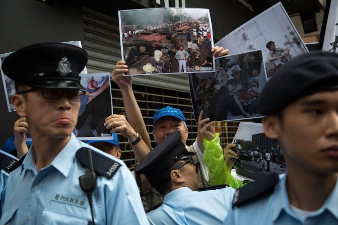 A pro-democracy group takes part in a rally outside the June 4 Museum on its opening day. A candlelight vigil commemorating the martyrs of the 1989 crackdown is held in the city's Victoria Park each year on June 4, attended by thousands. 