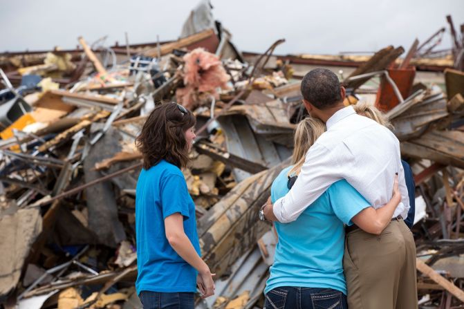 Hugging Amy Simpson, principal of Plaza Towers Elementary School, while viewing the remains of the school after a tornado in Moore, Oklahoma, on May 26, 2013.