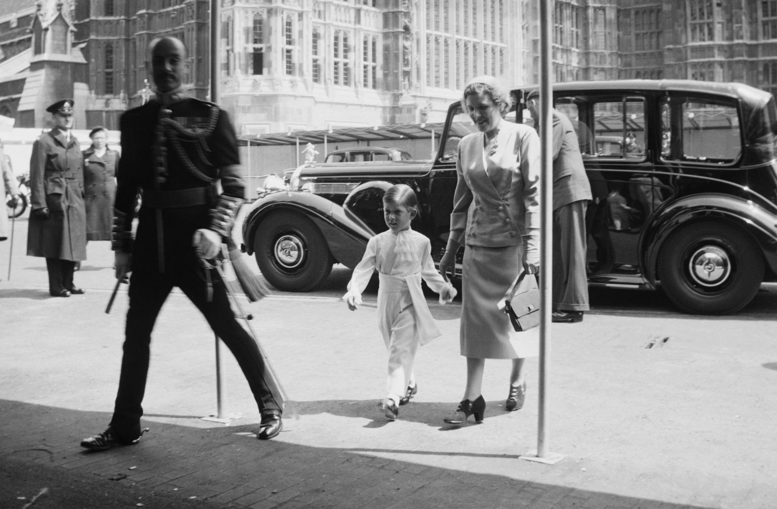 The Queen's son Prince Charles, accompanied by a nurse, arrives at Westminster Abbey.