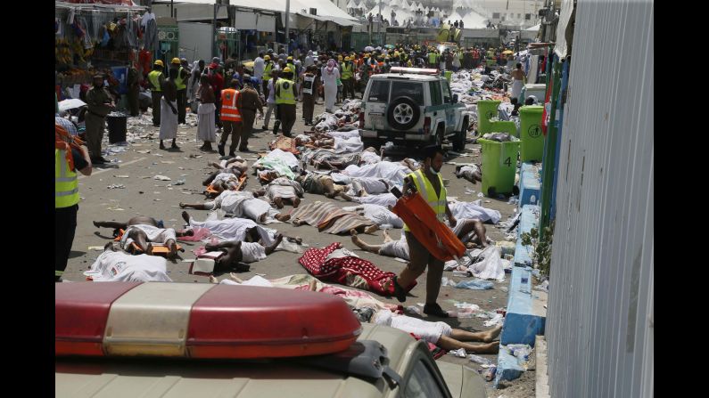 Bodies lie in the street as emergency personnel work.