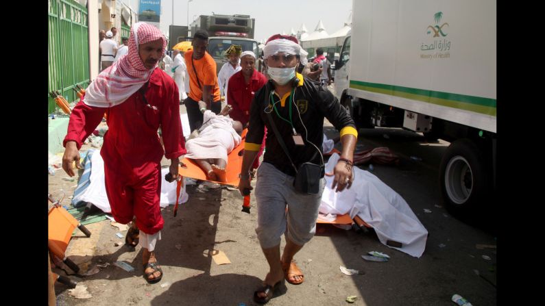 Emergency personnel carry an injured person.