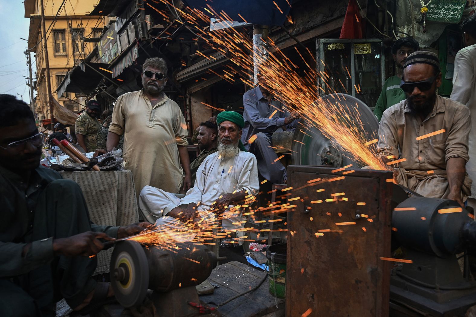 Blacksmiths sharpen knives at a shop in Karachi, Pakistan, on Friday, June 14, ahead of the Muslim festival of Eid al-Adha.