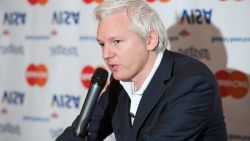 Wikileaks founder Julian Assange stands in front of a selection of inverted banking company logos as he speaks to journalists during a press conference at the Frontline Club in central London, England on October 24, 2011. Assange was announcing that due to financial blocks introduced by Bank of America, Visa, Mastercard, Paypal and Western Union, Wikileaks has lost 95% of it's revenue. With funds running low, the organisation has decided to suspend it's publishing operations to begin a period of fundraising and legal fighting to remove the blocks to donation channels.    AFP PHOTO/LEON NEAL (Photo credit should read LEON NEAL/AFP/Getty Images)