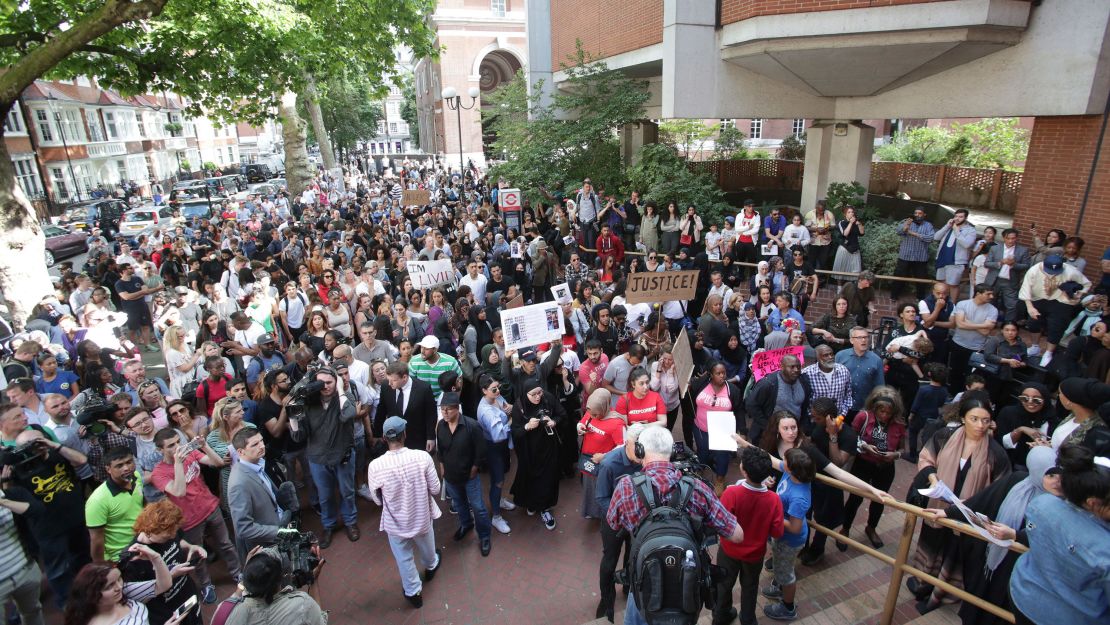 Protesters gather outside Kensington town hall in west London.