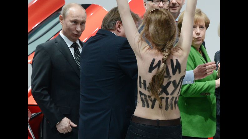 A topless protester shouts at Putin and German Chancellor Angela Merkel during a visit to central Germany in April 2013. That month, Putin <a href="http://www.cnn.com/2013/04/25/world/europe/russia-putin-questions/index.html" target="_blank">defended his government's record on free speech</a> and rejected a claim that it uses "Stalinist" methods to clamp down on critics and activists. Two international rights groups had issued scathing reports on Putin's presidency, saying changes to the law had helped authorities stifle dissent. 