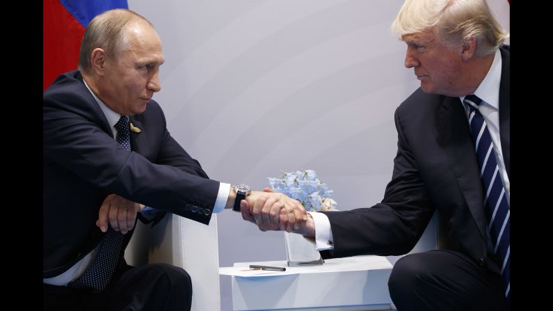 Putin shakes hands with US President Donald Trump <a href="http://www.cnn.com/2017/07/07/politics/trump-putin-meeting/index.html" target="_blank">as they meet on the sidelines</a> of the G20 summit in Germany in July 2017. They talked for more than two hours, discussing interference in US elections and ending with an agreement on curbing violence in Syria.