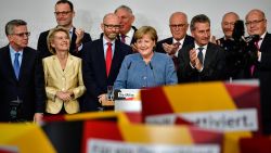 German Chancellor and Christian Democrat (CDU) Angela Merkel (C) reacts to initial results that give the party 32,9% of the vote, giving it a first place finish, in German federal elections on September 24, 2017 in Berlin, Germany. Chancellor Merkel is seeking a fourth term and coming weeks will likely be dominated by negotiations between parties over the next coalition government.