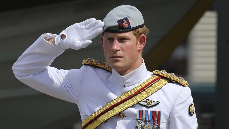 Harry receives a royal salute from the honor guard at the Garden Island naval base in Sydney in 2013.