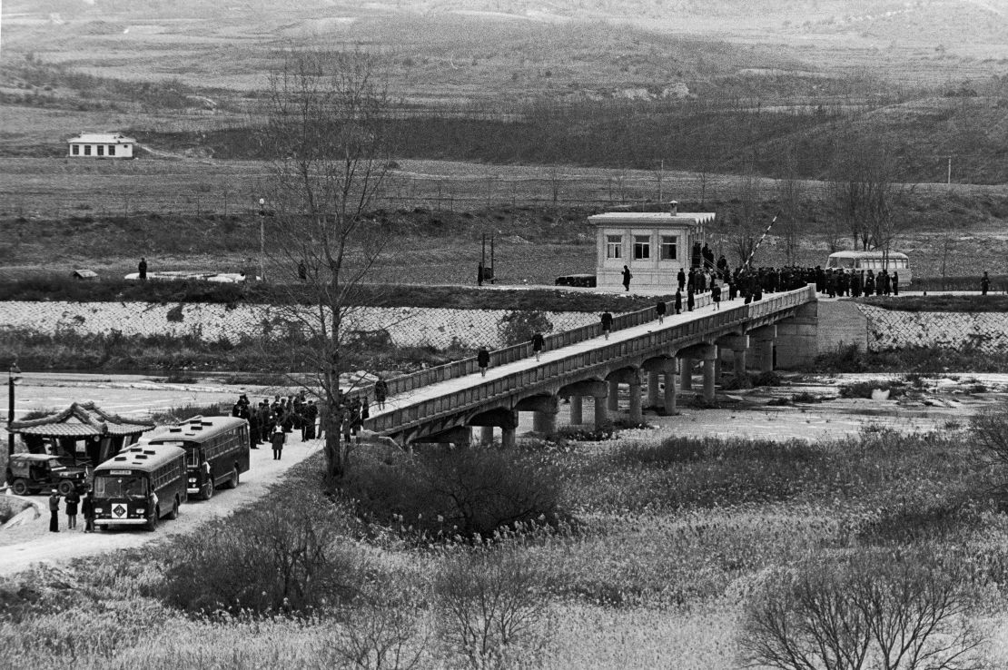 The USS Pueblo crew cross the Bridge of No Return between North and South Korea, after their release into US custody on December 23, 1968.