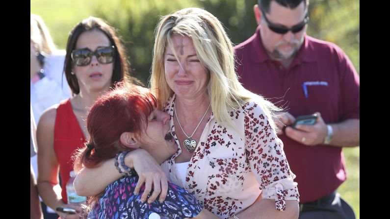 Parents wait for news after a shooting at Marjory Stoneman Douglas High School in Parkland, Florida, on Wednesday, February 14. <a href="https://www.cnn.com/2018/02/14/us/florida-high-school-shooting/index.html" target="_blank">At least 17 people were killed</a> at the school, Broward County Sheriff Scott Israel said. The suspect, 19-year-old former student Nikolas Cruz, is in custody, the sheriff said. The sheriff said Cruz had been expelled for unspecified disciplinary reasons.