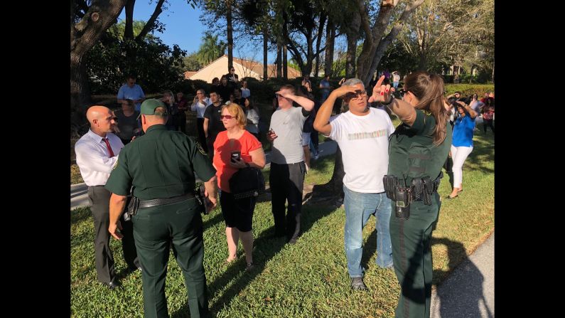 Security instructs parents following the shooting. Parents were told they would be reunited with their children at a local Marriott Hotel.