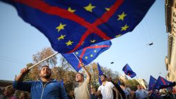 Supporters of the federalist and regionalist Italian political party, Lega Nord, and far-right activists wave a flag of the European Union with a red cross during a demonstration against immigration on October 18, 2014 in Milan.  AFP PHOTO / MARCO BERTORELLO        (Photo credit should read MARCO BERTORELLO/AFP/Getty Images)