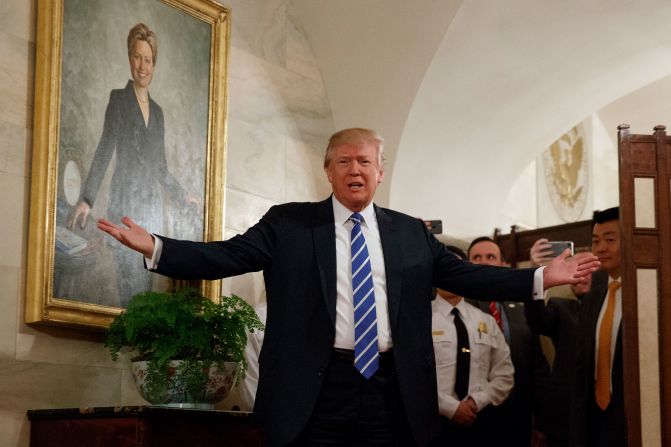 Trump, in front of a portrait of his 2016 opponent Hillary Clinton, <a href="http://www.cnn.com/2017/03/07/politics/trump-white-house-tour-surprise/" target="_blank">surprises visitors</a> who were touring the White House in March 2017. The tour group, including many young children, cheered and screamed after the president popped out from behind a room divider.