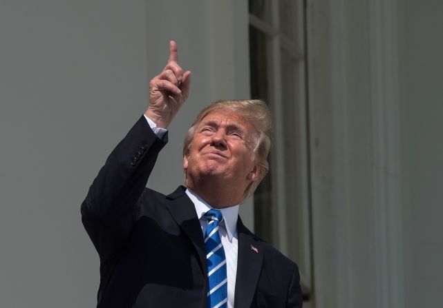 Trump <a href="http://www.cnn.com/2017/08/21/politics/trump-solar-eclipse/index.html" target="_blank">looks up at the sky</a> during the total solar eclipse in August 2017. He eventually put on protective glasses as he watched the eclipse with his wife and their son from the White House South Portico.