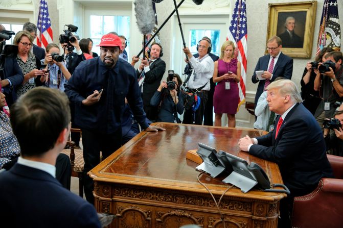 Rapper Kanye West stands up during his Oval Office meeting with Trump in October 2018. West and football legend Jim Brown <a href="https://www.cnn.com/2018/10/11/politics/kanye-west-donald-trump-white-house-chicago/index.html" target="_blank">had been invited for a working lunch</a> to discuss topics such as urban revitalization, workforce training programs and how best to address crime in Chicago. 