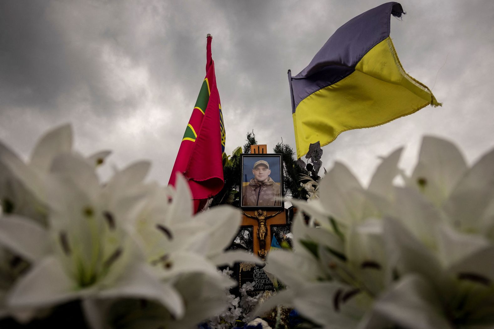 A Ukrainian flag flies over the grave of Stanislav Hulenkov in Lutsk, Ukraine, on Thursday, July 18. Hulenkov, <a href="https://www.reuters.com/sports/olympics/eve-olympics-ukraine-mourns-budding-athletes-lost-war-2024-07-23/" target="_blank">a 22-year-old rising judo star</a>, was killed while fighting against Russia.