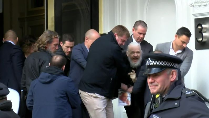 A screen grab from video footage shows the dramatic moment when Assange was <a href="https://edition.cnn.com/2019/04/11/uk/julian-assange-arrested-gbr-intl/index.html" target="_blank">hauled out of the Ecuadorian Embassy by police</a> in April 2019. Assange was arrested for "failing to surrender to the court" over a warrant issued in 2012. Officers made the initial move to detain Arrange after Ecuador withdrew his asylum and invited authorities into the embassy, citing his bad behavior.