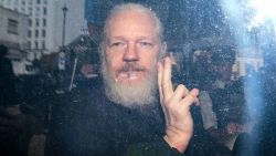 LONDON, ENGLAND - APRIL 11: Julian Assange gestures to the media from a police vehicle on his arrival at Westminster Magistrates court on April 11, 2019 in London, England.  After weeks of speculation Wikileaks founder Julian Assange was arrested by Scotland Yard Police Officers inside the Ecuadorian Embassy in Central London this morning. Ecuador's President, Lenin Moreno, withdrew Assange's Asylum after seven years citing repeated violations to international conventions. (Photo by Jack Taylor/Getty Images)