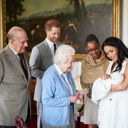 The Queen looks at <a href="http://www.cnn.com/2019/05/08/uk/gallery/archie-royal-baby-harry-meghan/index.html" target="_blank">her new great-grandchild, Archie,</a> in May 2019. Archie is the first child of Prince Harry, second from left, and his wife Meghan, the Duchess of Sussex. Prince Philip is on the far left. Meghan's mother, Doria Ragland, is next to her at right.