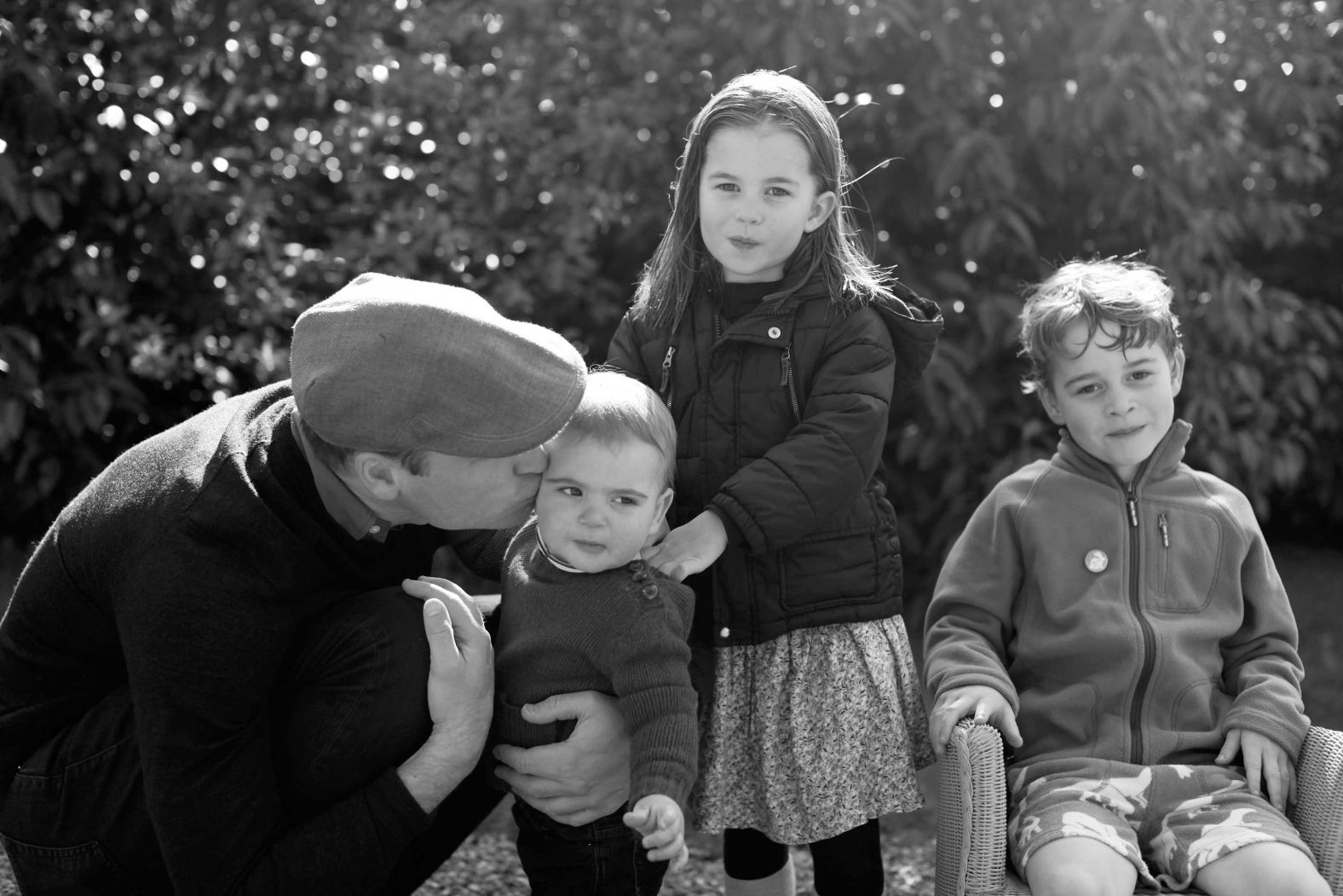 Prince William kisses his son Louis as they pose for a photo in Norfolk that was taken by Catherine in 2019.