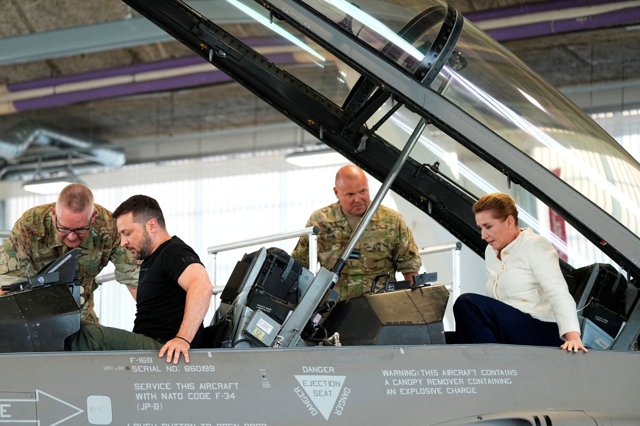 Ukrainian President Volodymyr Zelenskiy and Denmark's Prime Minister Mette Frederiksen sit in a F-16 fighter jet at Skrydstrup Airbase in Vojens, Denmark, on August 20, 2023.