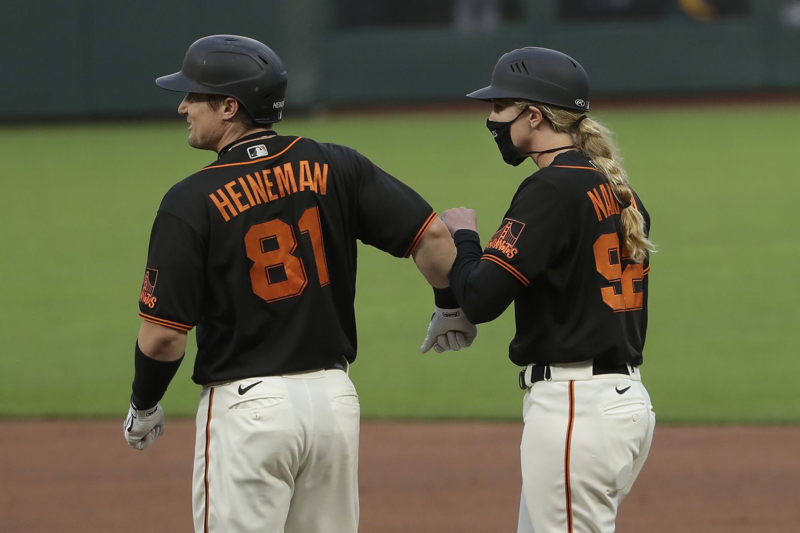 San Francisco's Tyler Heineman bumps forearms with first-base coach Alyssa Nakken during a preseason game on July 21. Nakken was making history as <a href="https://www.cnn.com/2020/07/21/us/woman-coach-san-francisco-giants-spt-trnd/index.html" target="_blank">the first woman to ever coach in Major League Baseball.</a>