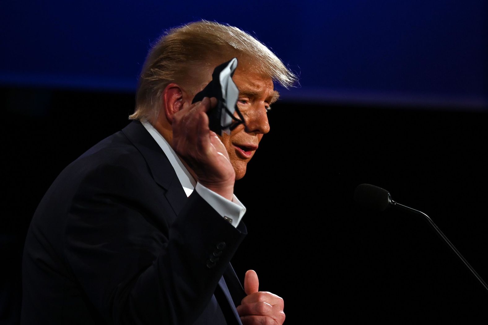 Trump holds a face mask as he speaks during the debate. "I don't wear a mask like (Biden), every time you see him, he's got a mask," <a href="https://www.cnn.com/politics/live-news/presidential-debate-coverage-fact-check-09-29-20/h_1e0c9b875c0fa789a2ffc63165f27d00" target="_blank">Trump said.</a> "He could be speaking 200 feet away from it, and he shows up with the biggest mask I've ever seen."