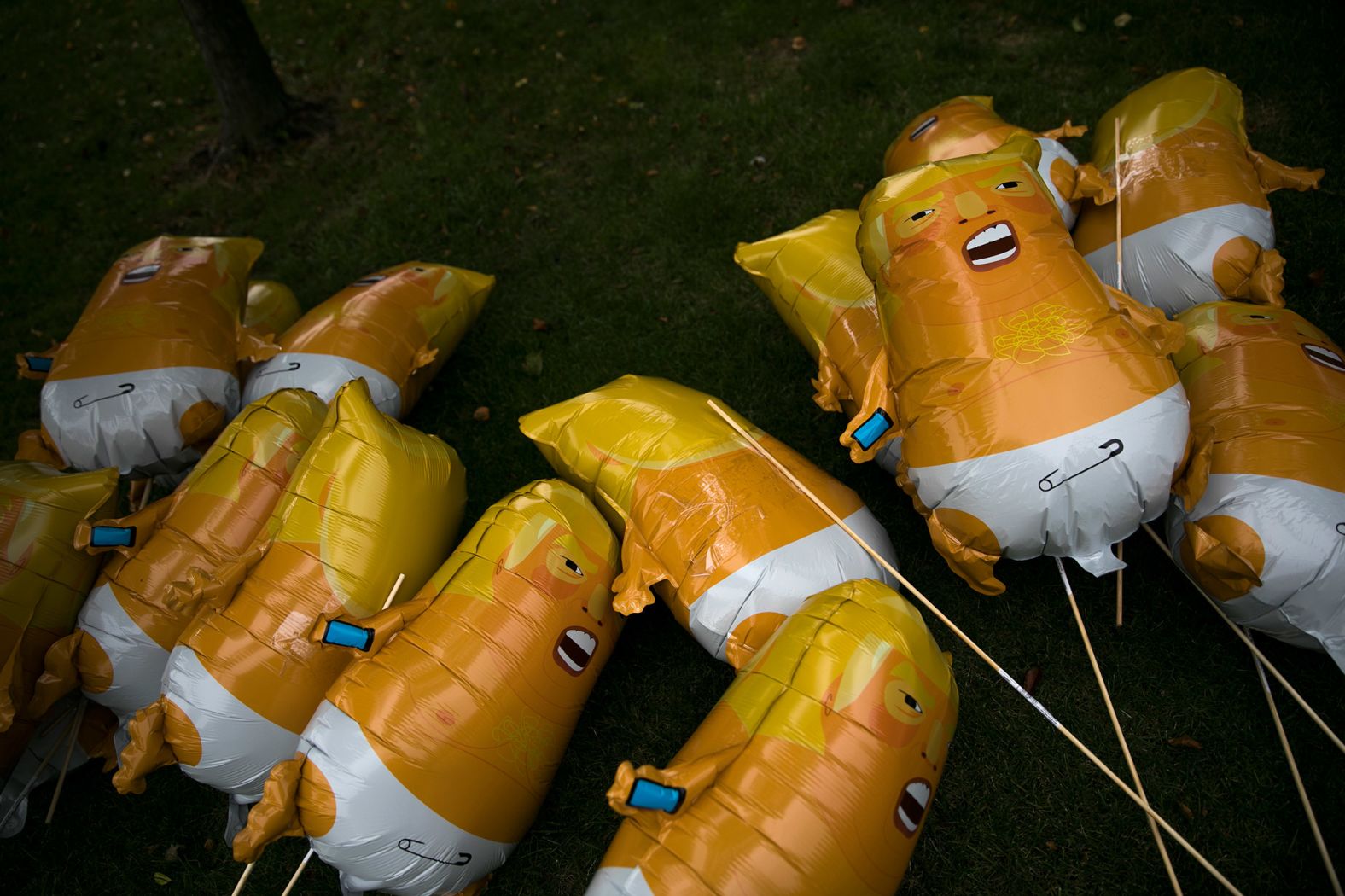 Baby Trump balloons lie on the ground at a protest in Cleveland before the debate.