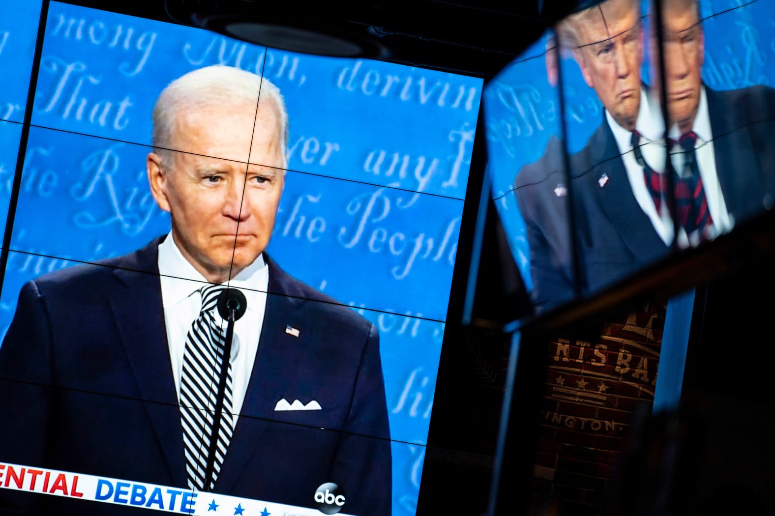 Television screens show the debate at the Walters Sports Bar in Washington, DC.