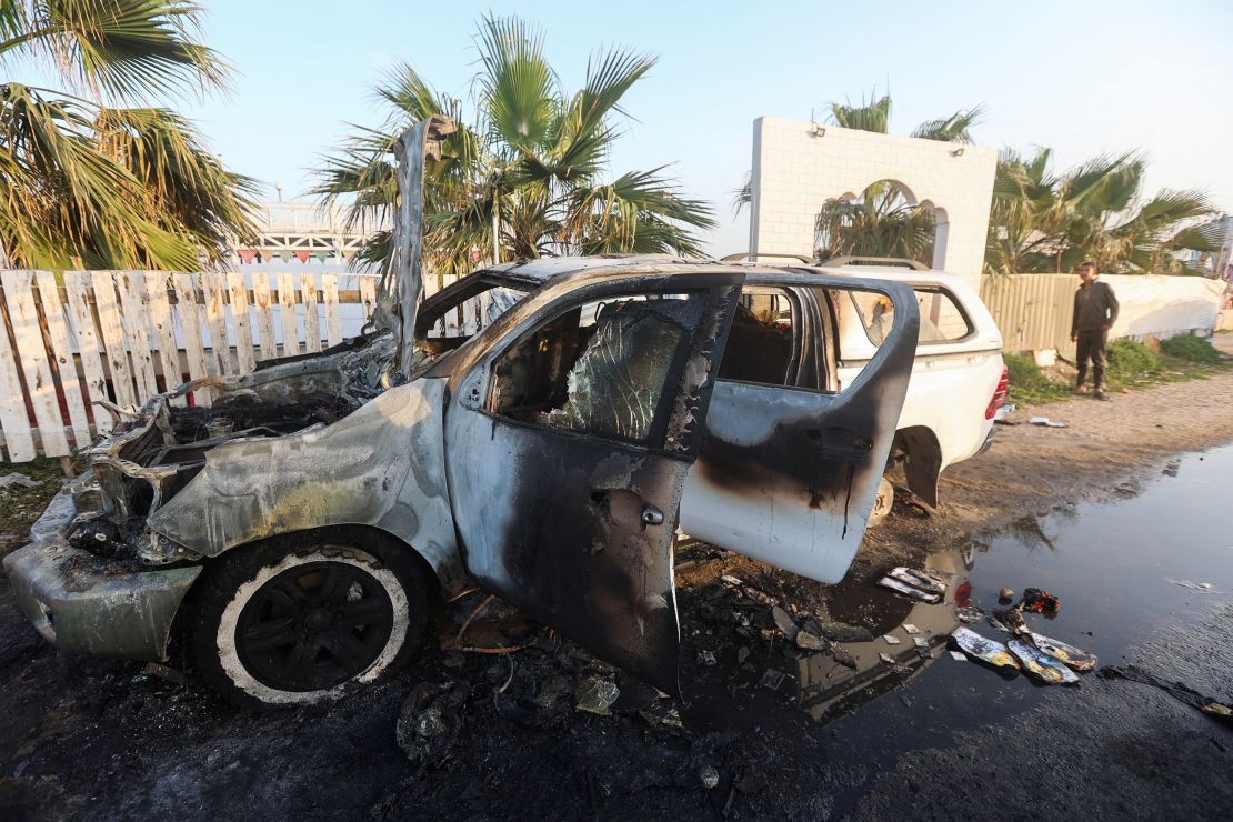 A person looks at a vehicle where aid workers from the World Central Kitchen were killed in an airstrike