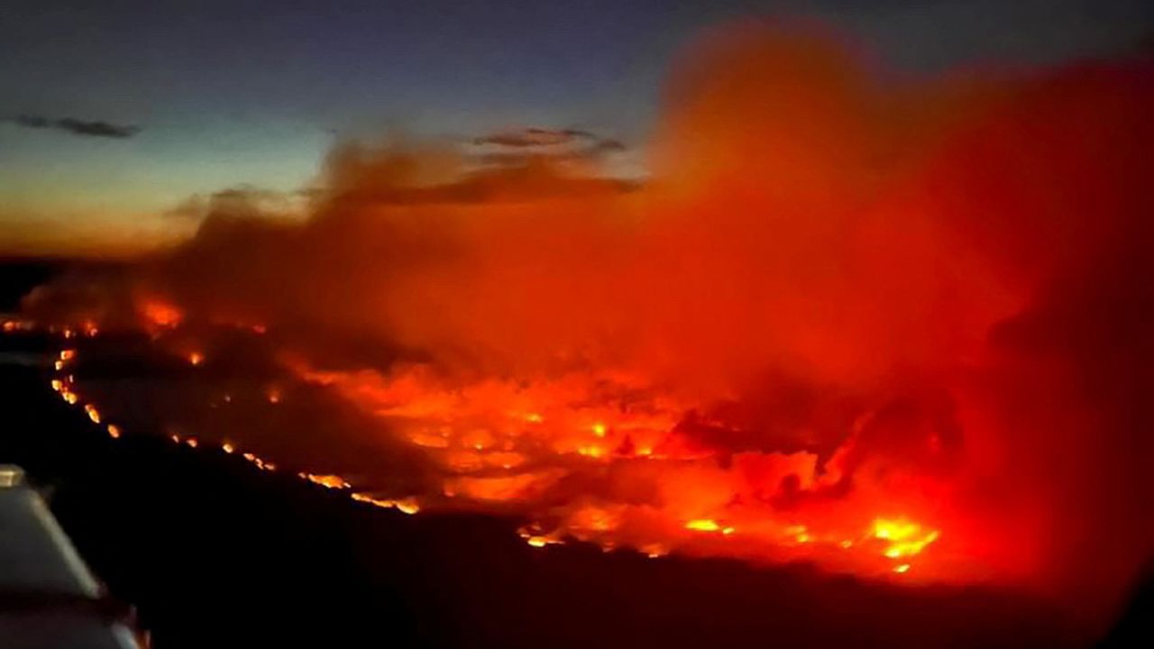 The Parker Lake wildfire glows in an aerial photograph taken by a B.C. Emergency Health Services crew member through the window of an airplane evacuating patients from nearby Fort Nelson, British Columbia, Canada May 10, 2024. Thousands of residents in Northern Rockies Regional Municipality and Fort Nelson First Nations were evacuated, mainly by road to the south, as the nearby blaze nearly doubled in size to 4,136 hectares (10,220 acres) by May 12.  Andrei Axenov/BCEHS/Handout via REUTERS  NO RESALES. NO ARCHIVES. THIS IMAGE HAS BEEN SUPPLIED BY A THIRD PARTY. THIS PICTURE WAS PROCESSED BY REUTERS TO ENHANCE QUALITY. AN UNPROCESSED VERSION HAS BEEN PROVIDED SEPARATELY 